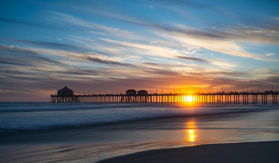 Huntington Beach pier stretching into the Pacific Ocean at golden hour